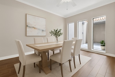 Elegant dining space with floor-to-ceiling windows overlooking the atrium, perfect for hosting (virtually staged).