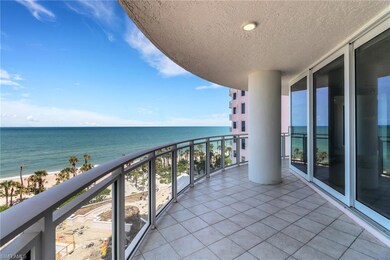 Balcony featuring view of water and beach