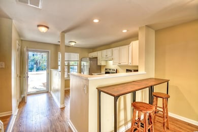 Kitchen with baseboards, light wood finished floor