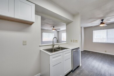 Kitchen featuring sink, ceiling fan, white cabinet