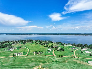 Aerial view of property's location featuring a large body of water