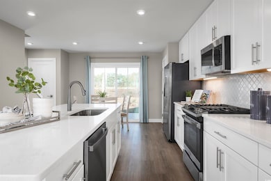 Kitchen featuring stainless steel appliances, whit