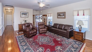 Living room with light hardwood / wood-style floor