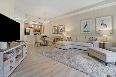 Living room with a chandelier and light hardwood / wood-style flooring