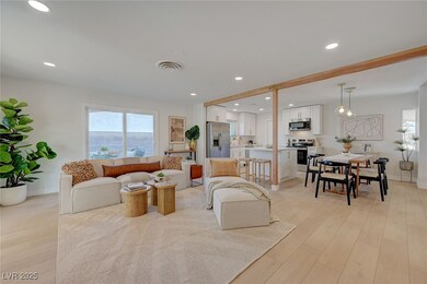 Living area with light wood-style floors, baseboar