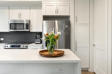 Kitchen with backsplash, light countertops, stain