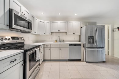 Stainless steel appliances and ample cabinets for storage.