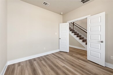 Unfurnished room featuring hardwood / wood-style f