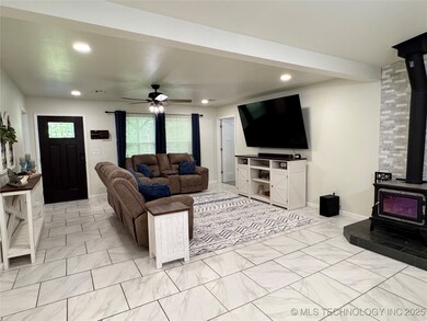 Spacious and stylish living room with tile floorin