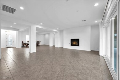 Unfurnished living room featuring tile patterned f