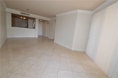 Empty room with visible vents, crown molding, base