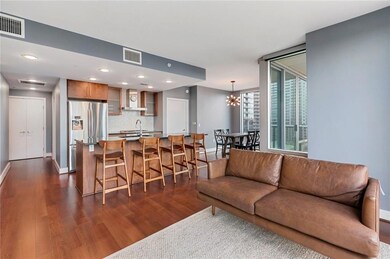 Living room featuring dark wood-style floors, bas