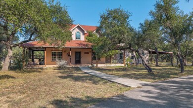 View of front of house featuring covered porch, a front lawn, and stucco siding