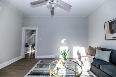 Living room with dark hardwood / wood-style floors and ornamental molding