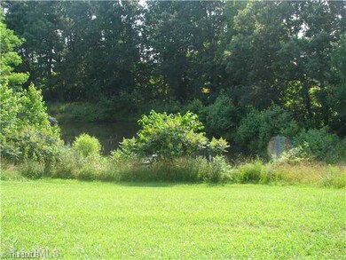 Exterior Back. Back yard view of pond