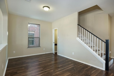 Spare room with wood finished floors, stairs, and