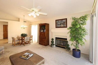 Living room has a fireplace, vaulted ceiling and o