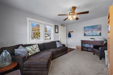 Living room featuring ceiling fan and wood finished floors