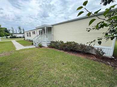 View of front of home featuring a front yard and c