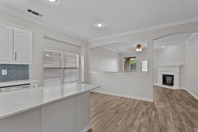 Kitchen with ceiling fan, light hardwood / wood-st