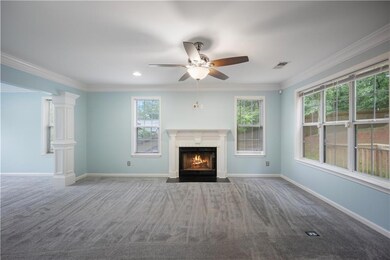 Carpeted foyer entrance with ornamental molding, s
