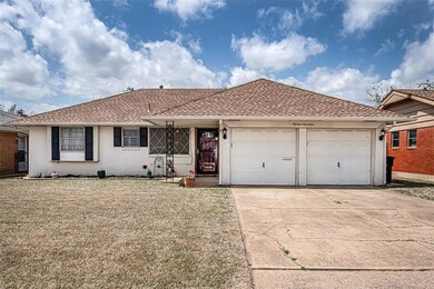Ranch-style home with a front yard and a garage