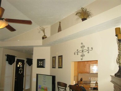 Greatroom has high ceiling & plant shelf