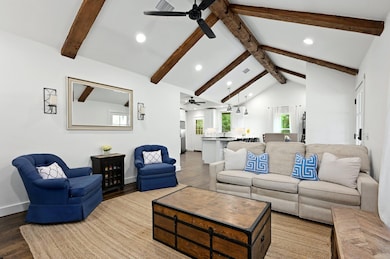 Living area with a ceiling fan, wood finished flo