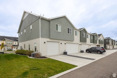 View of home's exterior with a residential view, driveway, a garage, a lawn, and board and batten siding