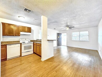 Kitchen with brown cabinetry, under cabinet range