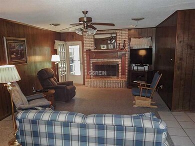 Photo. Spacious den with gas or wood burning firep