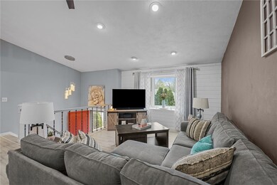 Living room with decorative wall and recessed ligh