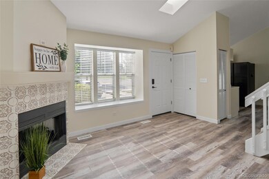 Living room w/ electric fireplace and bay window.