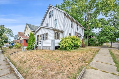 View of side of home featuring a lawn