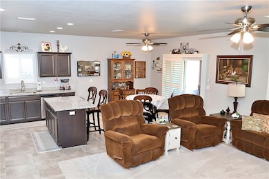 Living area featuring a ceiling fan