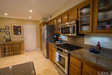 Kitchen has granite counters and stainless applian