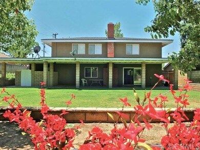 Large relaxing backyard with fruit trees and heirloom tomato plants.