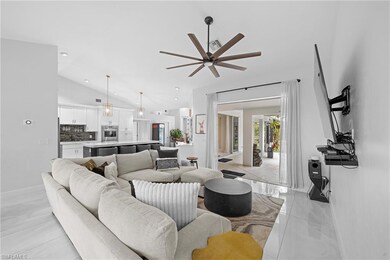 Living room with lofted ceiling, light tile patter