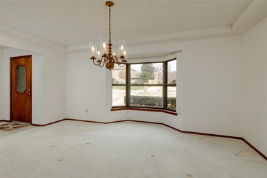 Carpeted spare room with a textured ceiling, an in