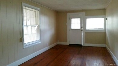 Bedroom area; exposed hardwood flooring