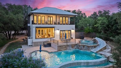 Back of property featuring an in-ground hot tub, 