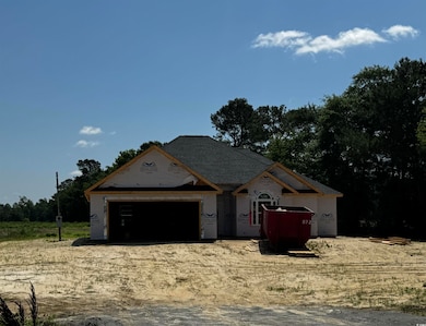 Property under construction featuring an attached garage