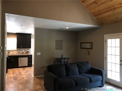 The living room is large enough for a table and ch