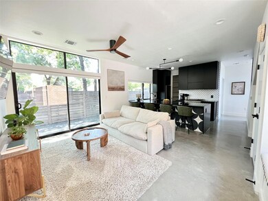 Living area featuring baseboards, finished concre