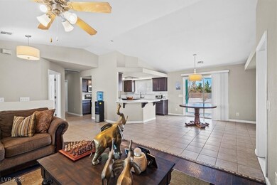 Living area with a ceiling fan, light tile pattern