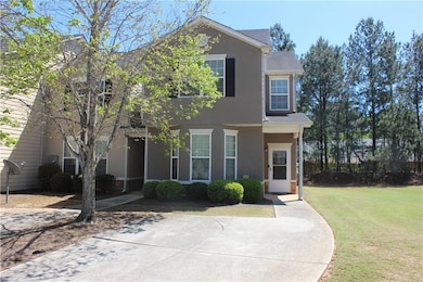 Traditional-style house featuring a front lawn and stucco siding