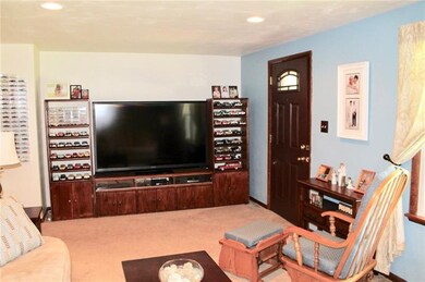 Living room is bright and airy with recessed light