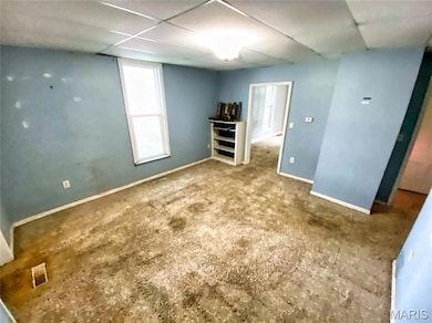 Unfurnished bedroom with carpet flooring and a drop ceiling