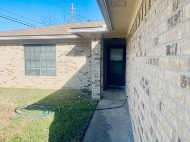 View of exterior entry with brick siding