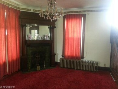 Beautiful fireplace in parlor room with hardwood t